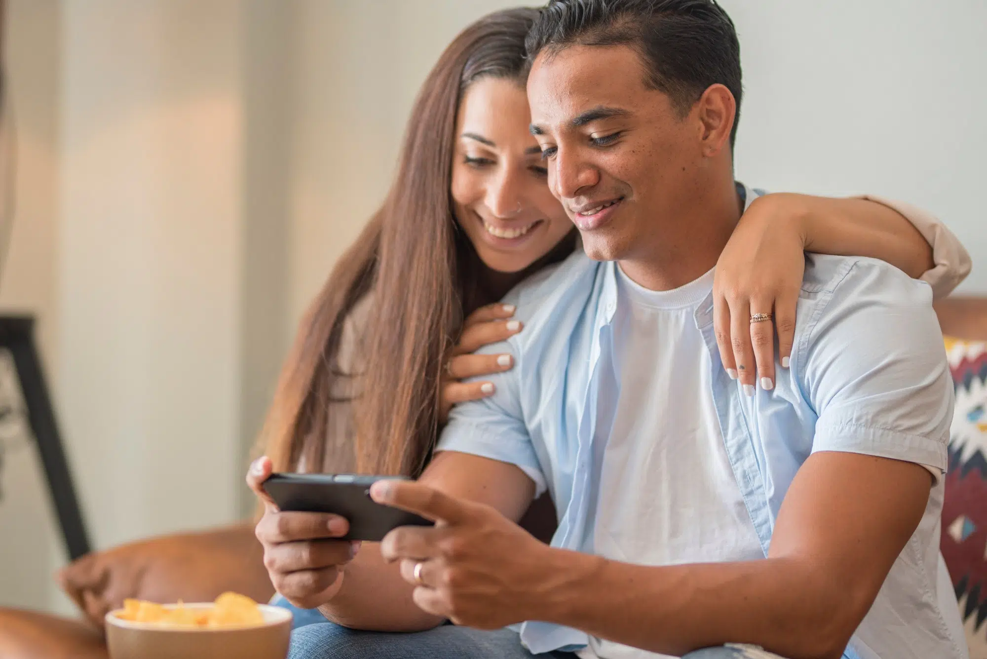Portrait of cheerful positive young lovely couple smiling spending time together